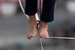 FILE - A French slackliner balances on a 230-foot slackline in Paris in 2021. The little-known extreme sport, also called highlining, has grown in popularity, including in the U.S. On Jan. 2, 2026, four Oregonians died after the helicopter they were in likely collided with a slackline strung across a canyon in Arizona, according to local authorities. The NTSB is investigating.