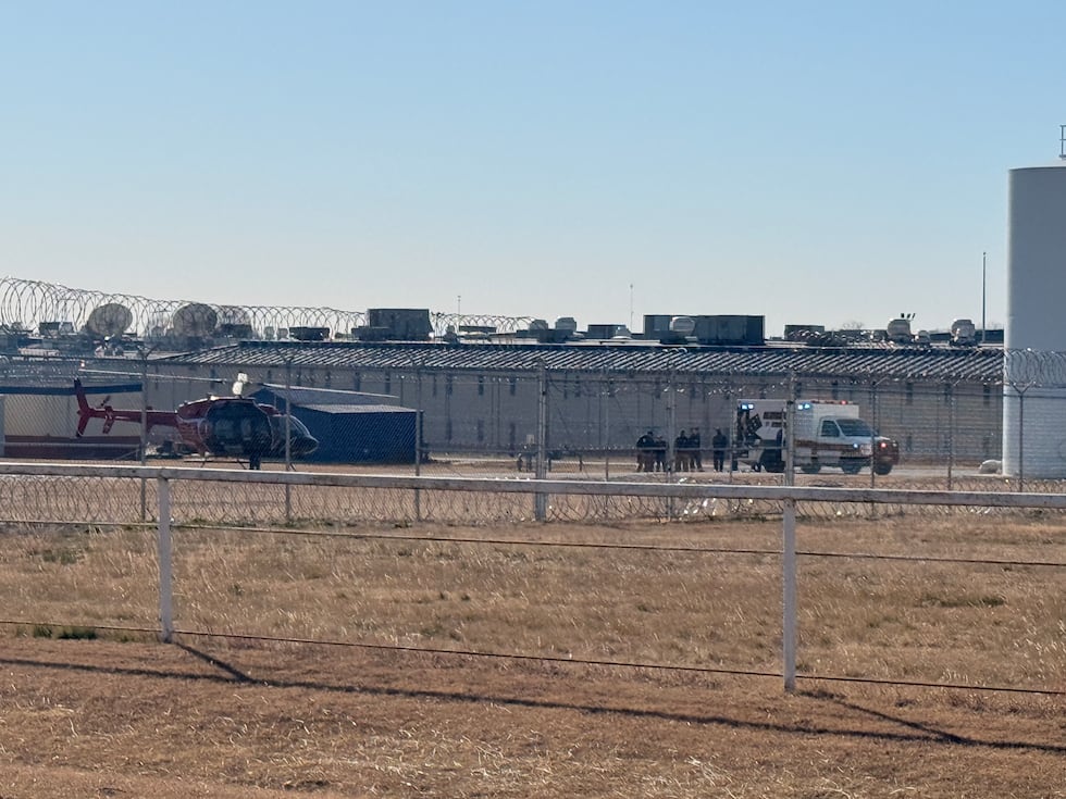 A patient is loaded onto a helicopter to be take for treatment.