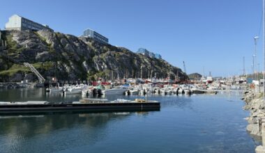 Private fishing boats and state-owned trawlers fill Nuuk's industrial harbor. While usually a peaceful economic hub, the waterfront has become a focal point for regional security as the recent landing site for Danish special forces. Credit: Johnny Sturgeon/InsideClimate News