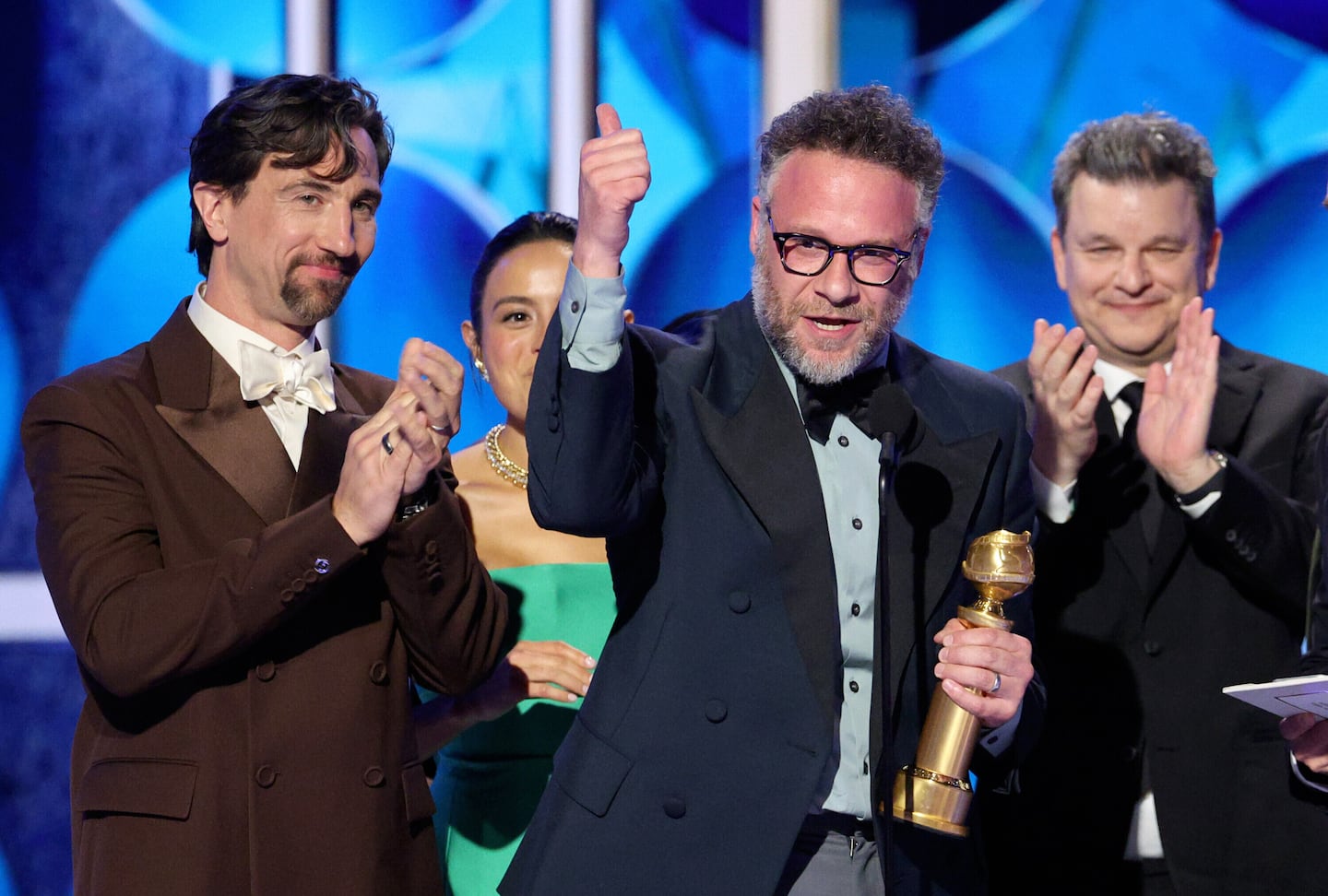 This image released by CBS Broadcasting shows James Weaver, from left, Chase Sui Wonders, Seth Rogen and Alex Gregory accepting the award for best TV series, musical or comedy for "The Studio" during the 83rd Golden Globes on Sunday at the Beverly Hilton in Beverly Hills, Calif.