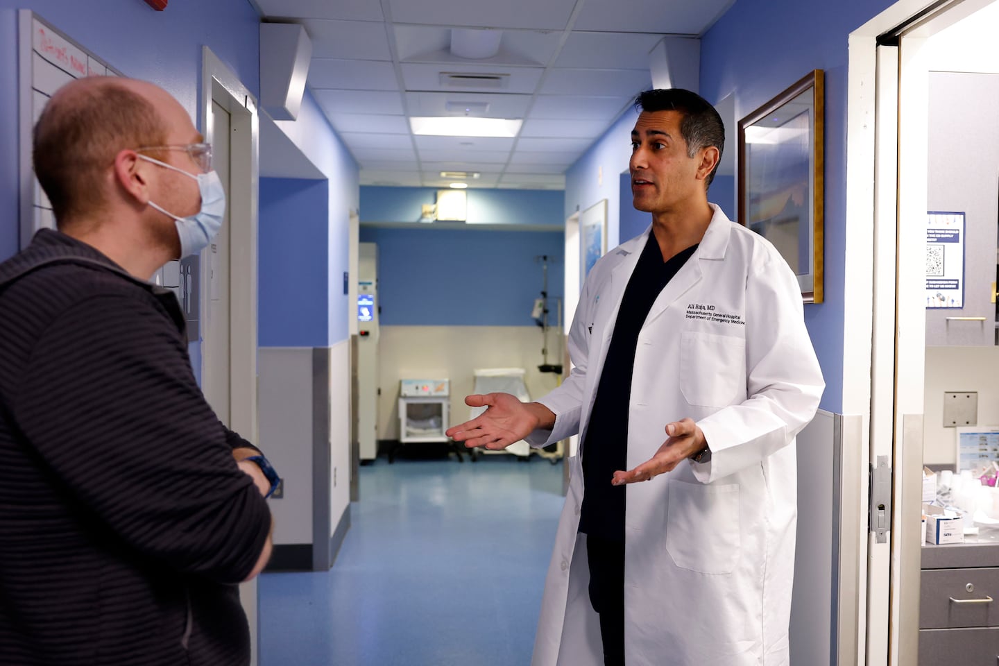 Dr. Ali Raja (right), executive vice chair of emergency medicine at Mass General Brigham, spoke to Paul Schneider, a certified physician assistant.