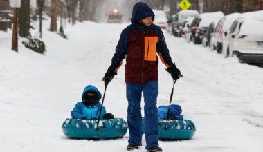 David Friedman (center) pulls his sons Noah, 5, (left), and Zachary, 3, along South Third Street in Society Hill. This was the heftiest snow since February 2021.