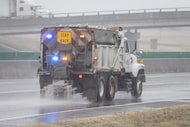 A TxDOT vehicle treats Interstate 20 for ice during a winter storm on Saturday, Jan. 24,...