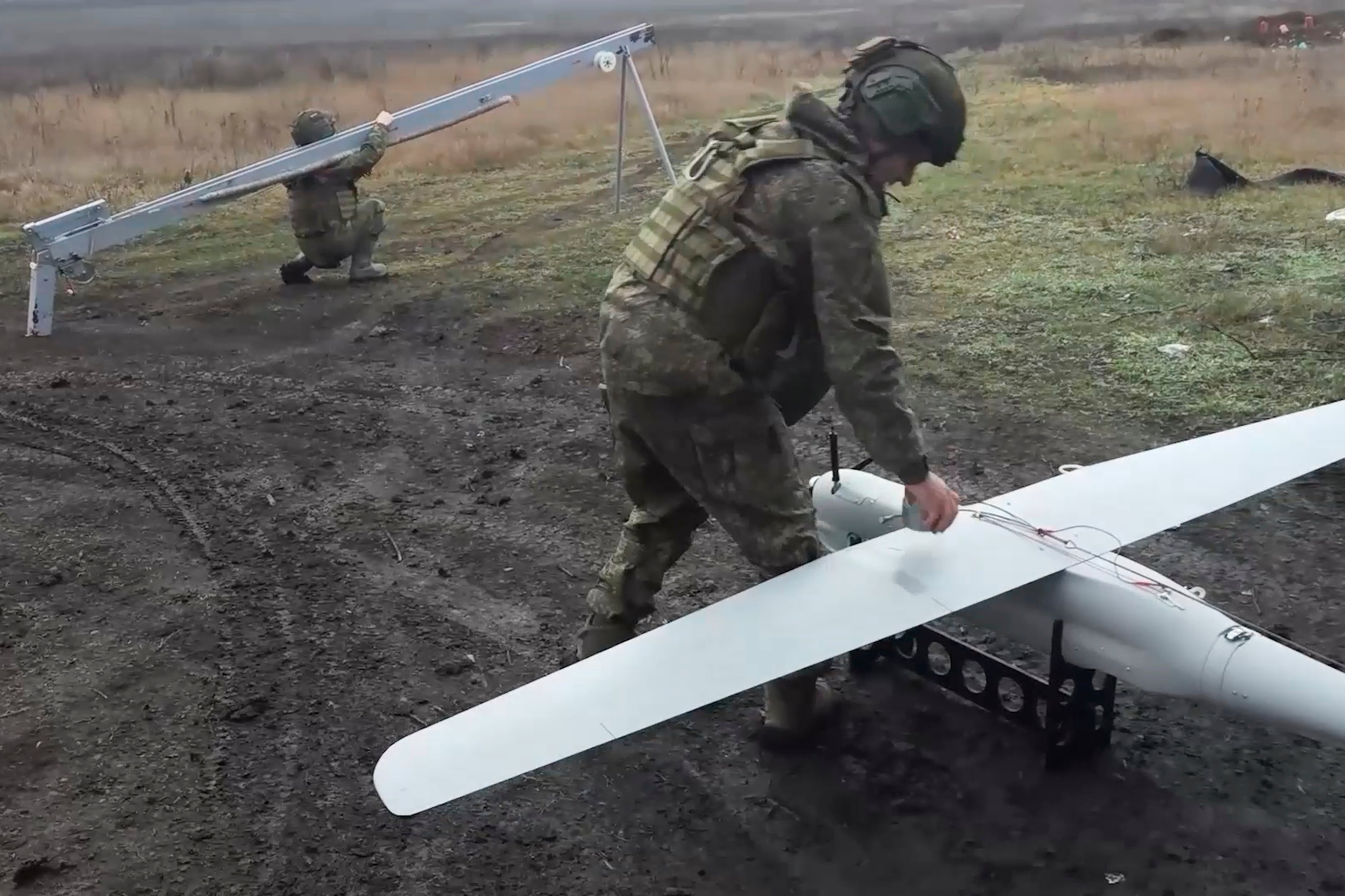 Russian soldiers prepare a drone to launch for an action in an undisclosed location in Ukraine
