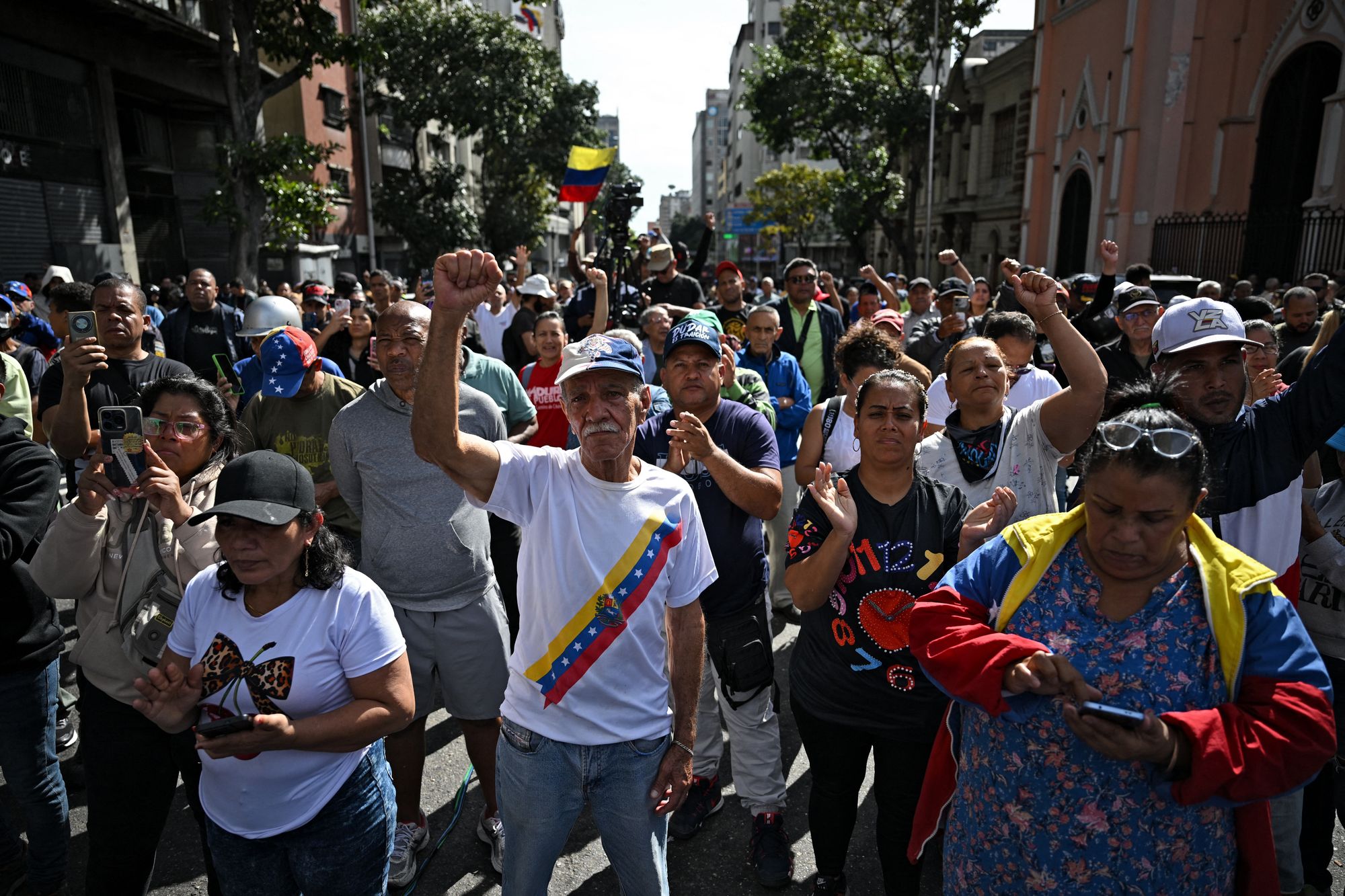 Supporters of Maduro react to the news in Caracas