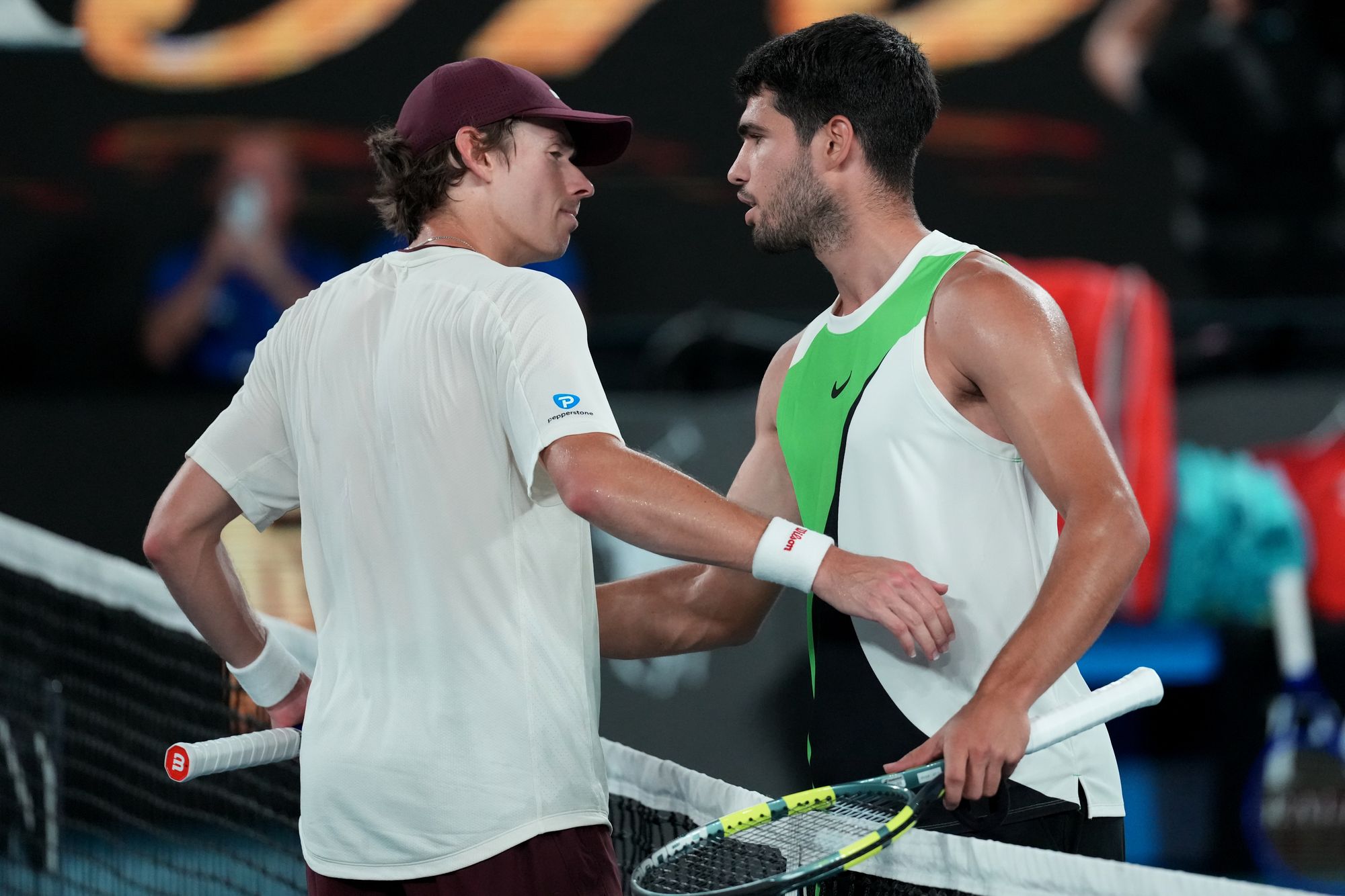 Carlos Alcaraz is congratulated by Alex de Minaur after the 7-5 6-2 6-1 win