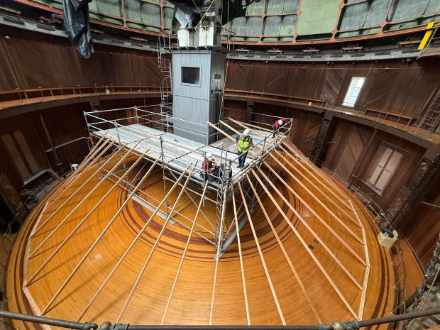 Workers build a frame to hold plastic sheeting intended to protect sensitive equipment and the wooden floor of the damaged dome holding the Great Refractor telescope at Lick Observatory atop Mount Hamilton east of San Jose, Calif. (Jamey Eriksen/Lick Observatory)