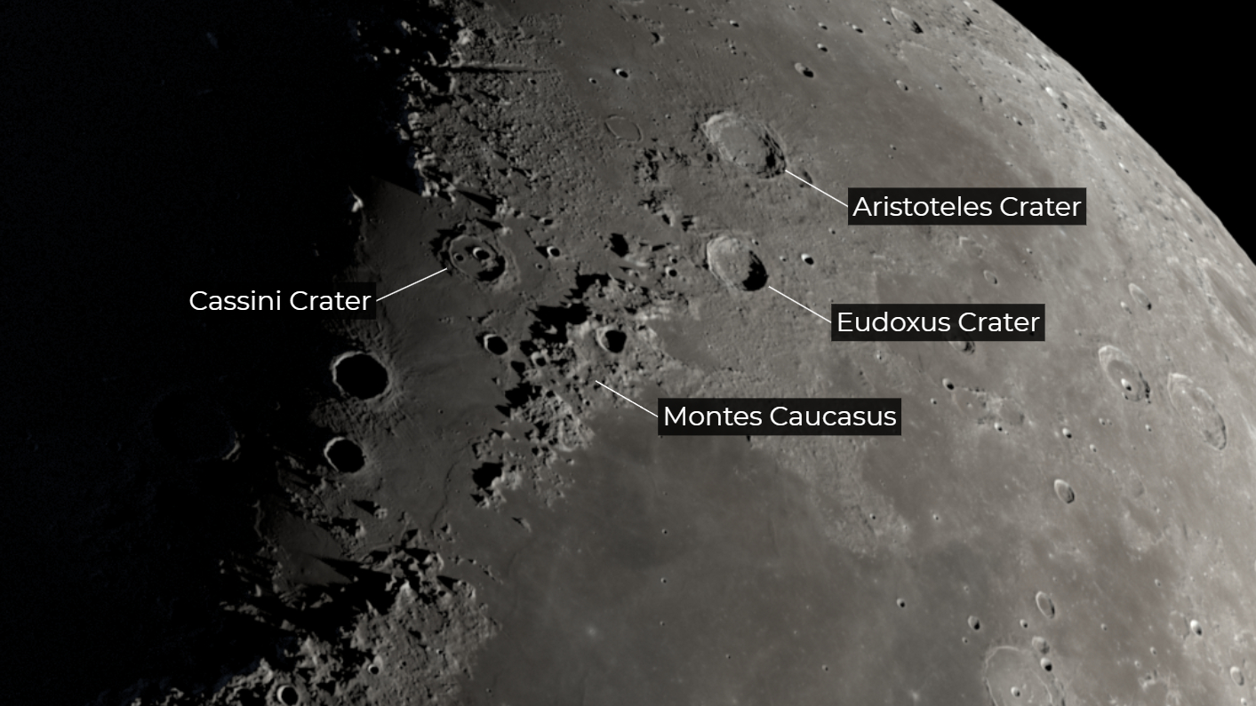 A section of the moon is pictured against a black sky, with the location of the Cassini Crater labelled close to the line separating night from day, known as the "terminator".