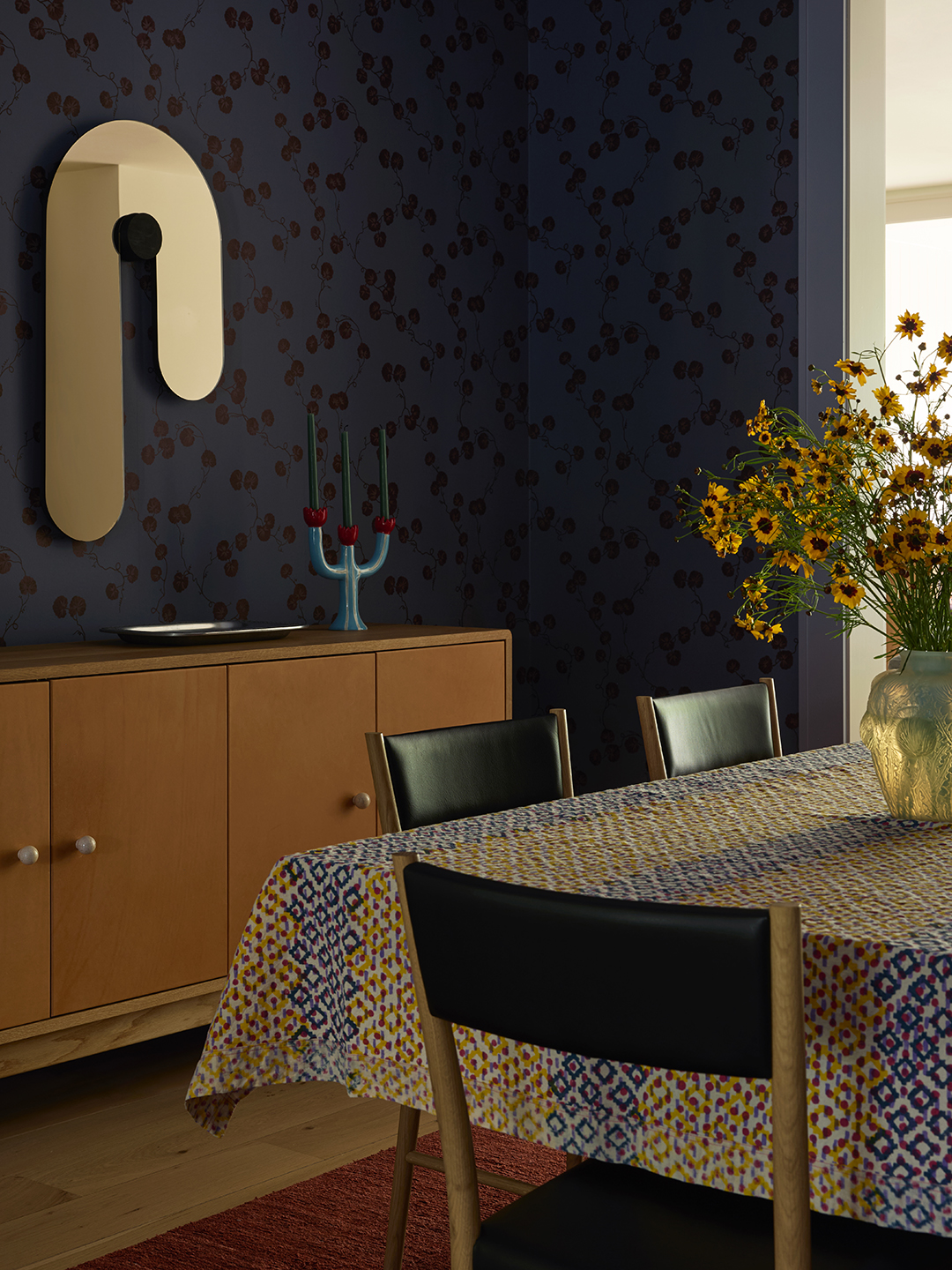 dining room with dark blue floral wallpaper