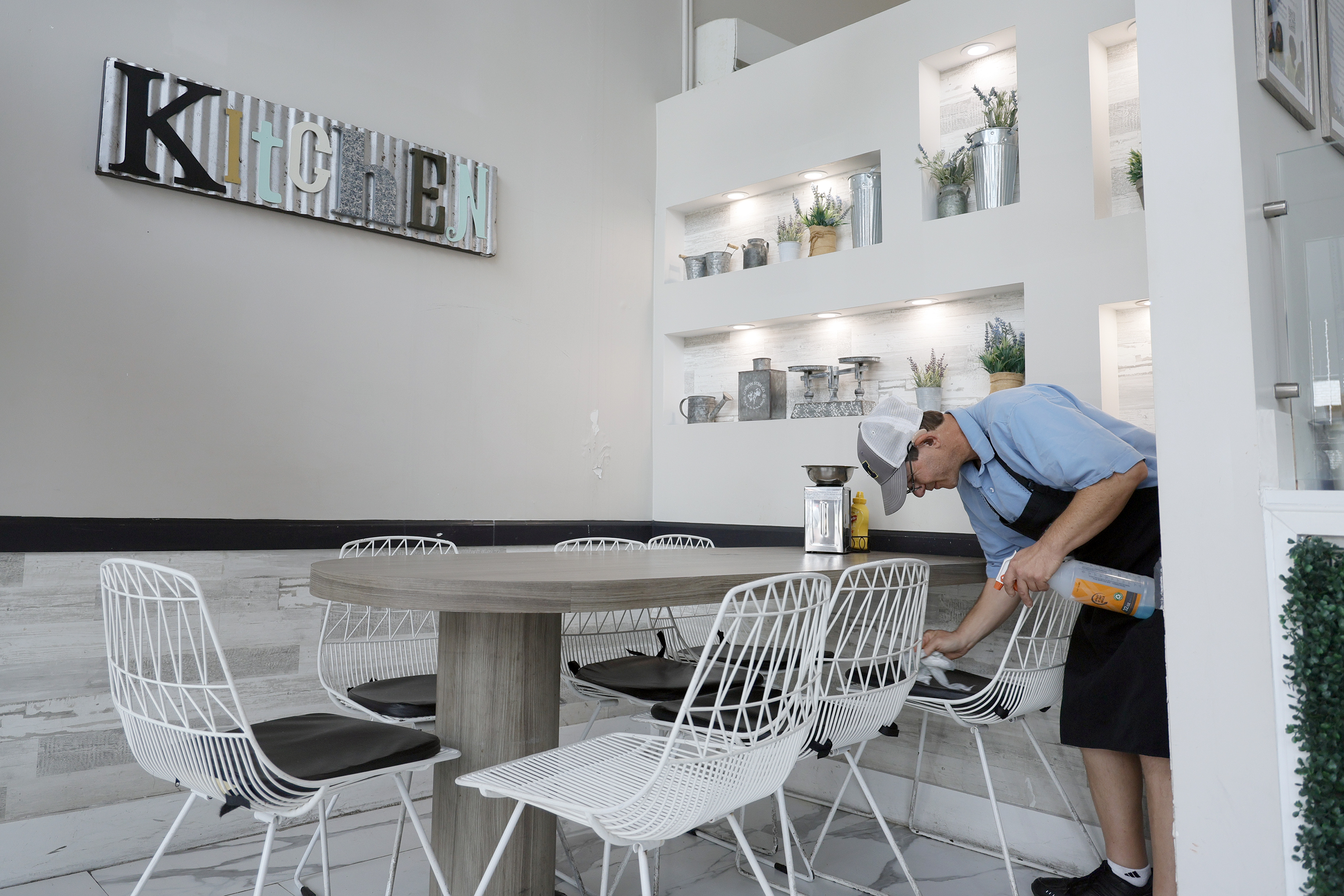 Student Randy Kugler cleans a table in the dining room...