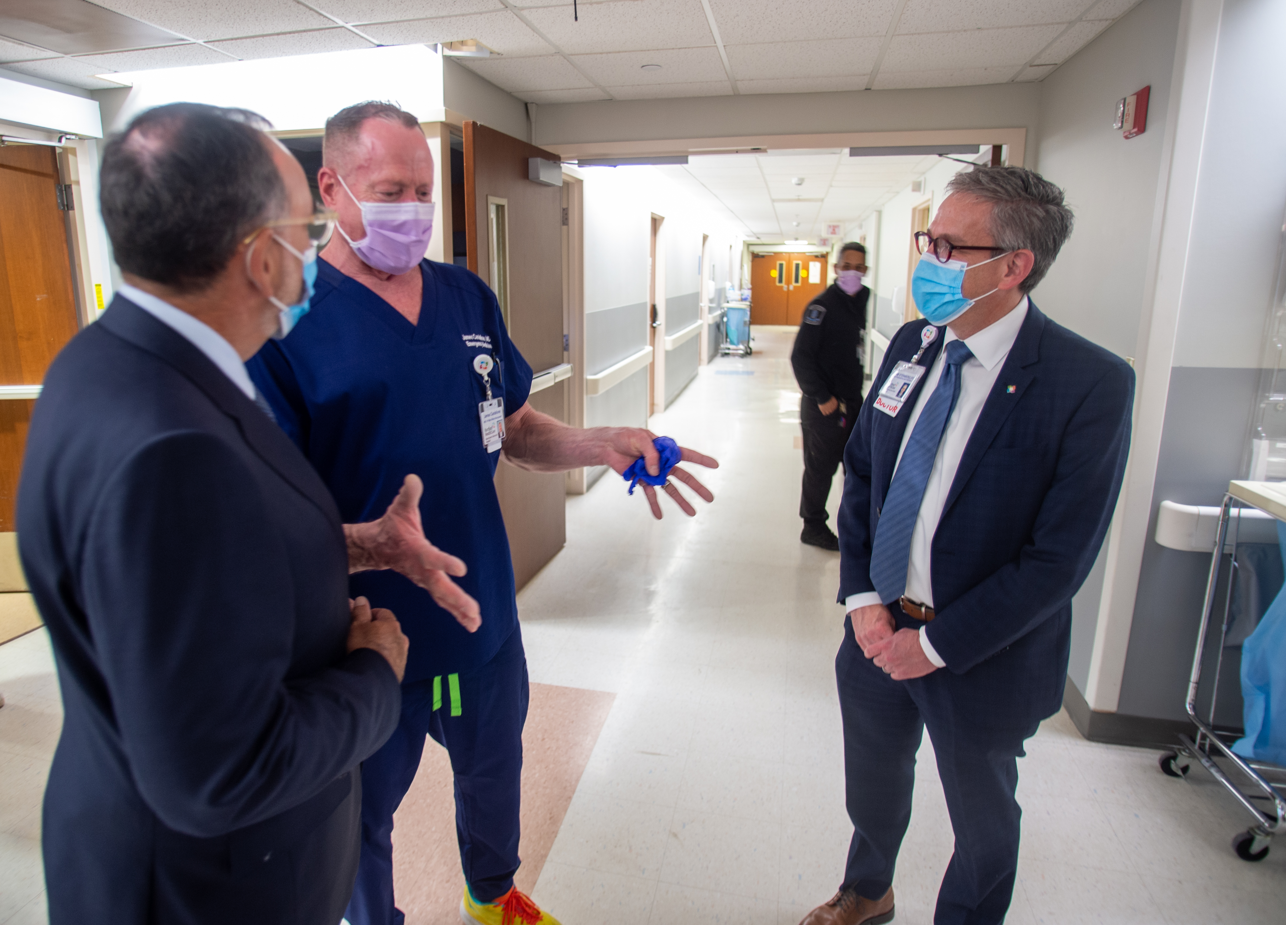 James Castellone, an emergency medicine physician, center, talks with Jeff...