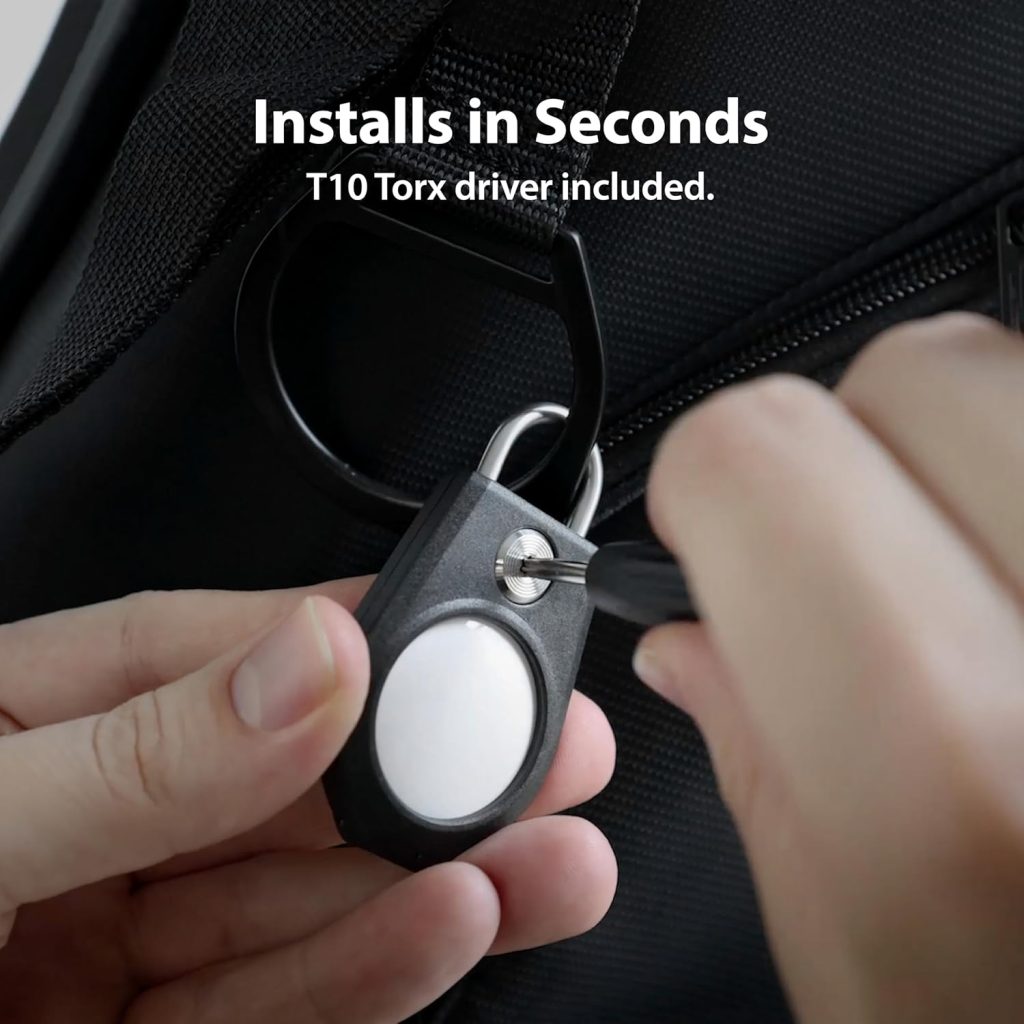 A person holding a key with a screwdriver