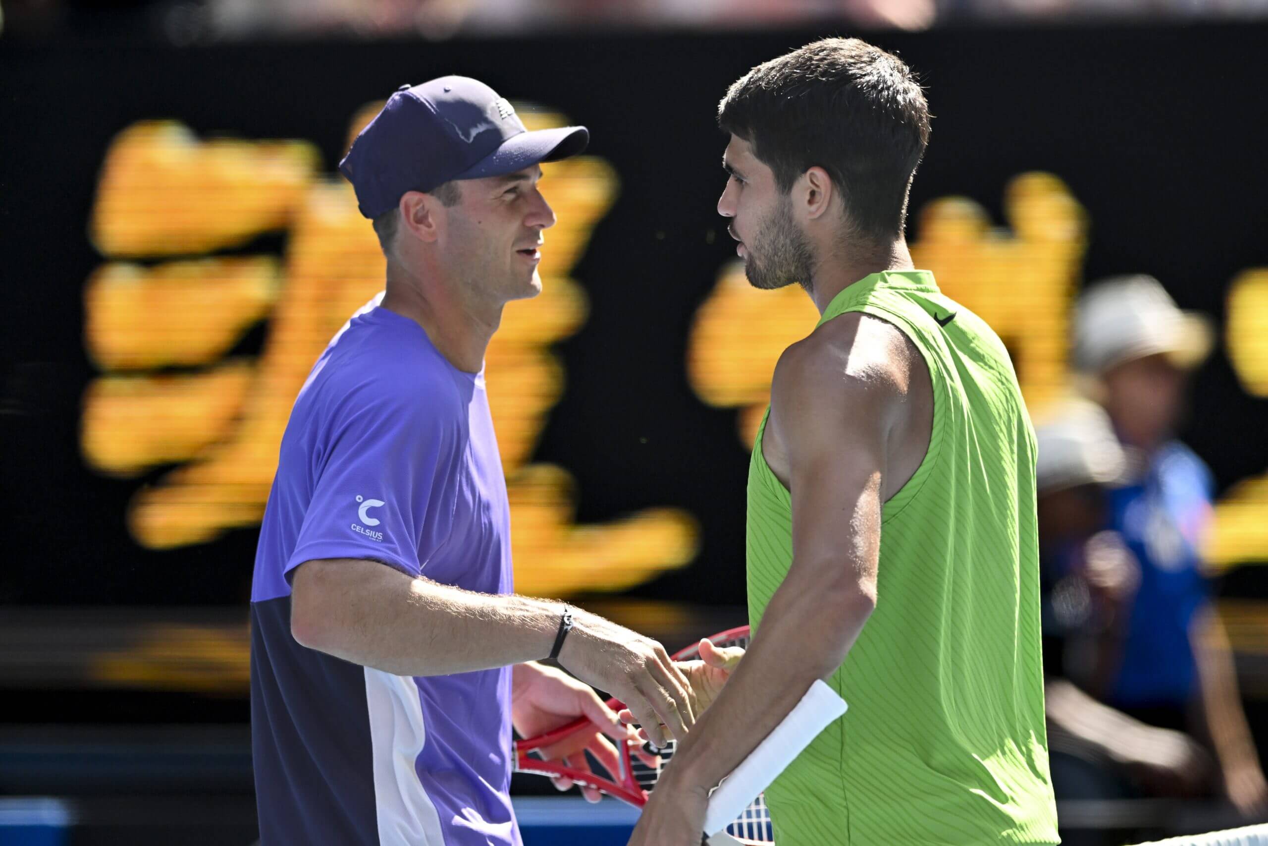 Tommy Paul (left) and Carlos Alcaraz (right) embrace at the net.