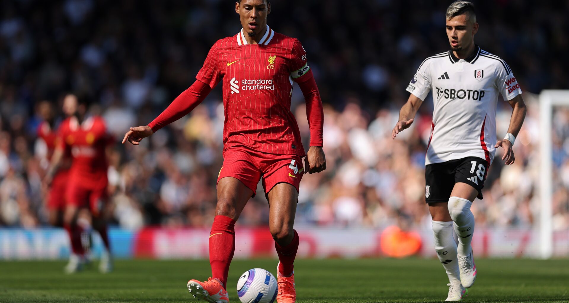 Virgil van Dijk plays a pass against Fulham.