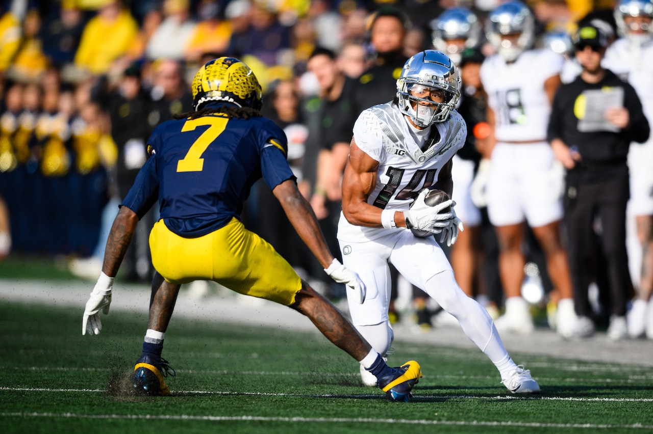 Oregon’s Justius Lowe (14) looks for running room as the No. 1 Ducks face the Michigan Wolverines in a Big Ten football game on Saturday, Nov. 2, 2024, at Michigan Stadium in Ann Arbor.