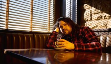 Wolfgang Van Halen in a diner booth, drinking coffee