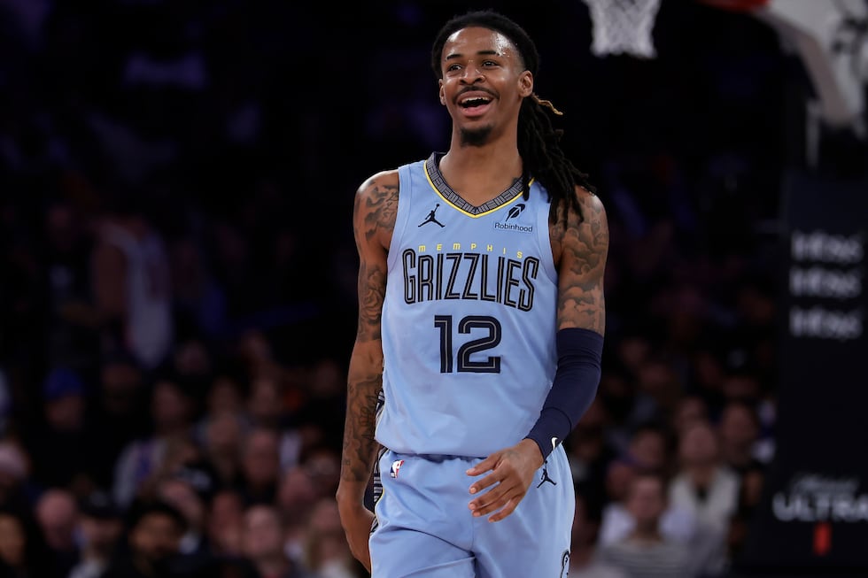 Memphis Grizzlies guard Ja Morant (12) reacts during the second half of an NBA basketball game...