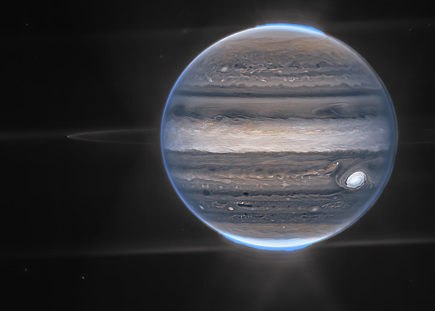 A composite image of the Jupiter system taken by the James Webb Space Telescope.