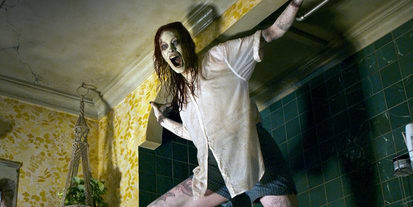 A scary woman hangs from a ceiling in Evil Dead Rise