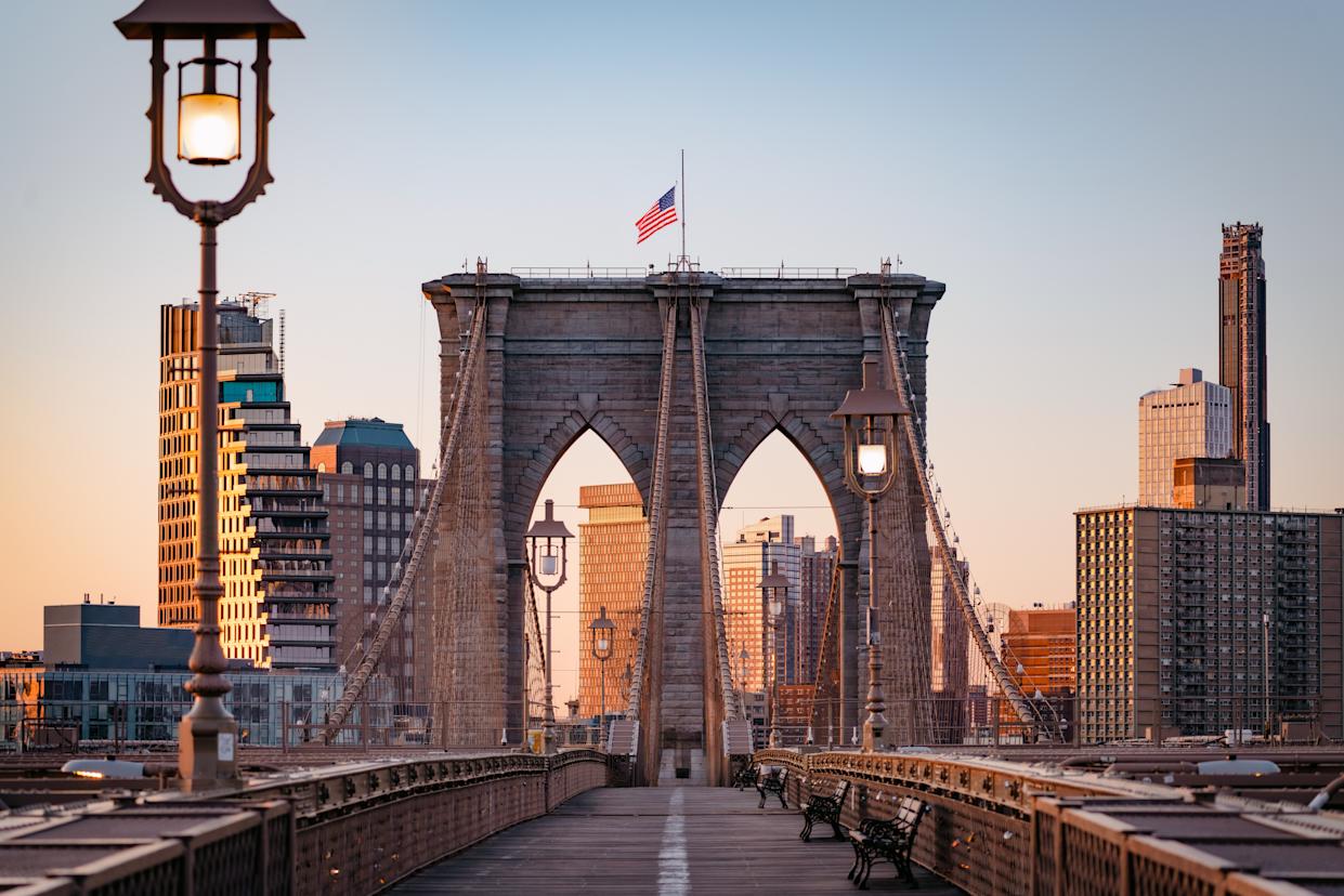 Woman tourist watching Brooklyn Bridge, New York City, USA