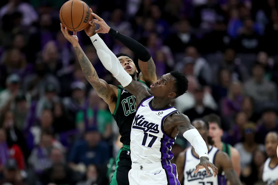 Jan 1, 2026; Sacramento, California, USA; Sacramento Kings guard Dennis Schroder (17) and Boston Celtics guard Anfernee Simons (4) battle for a rebound during the third quarter at Golden 1 Center. Mandatory Credit: Dennis Lee-Imagn Images