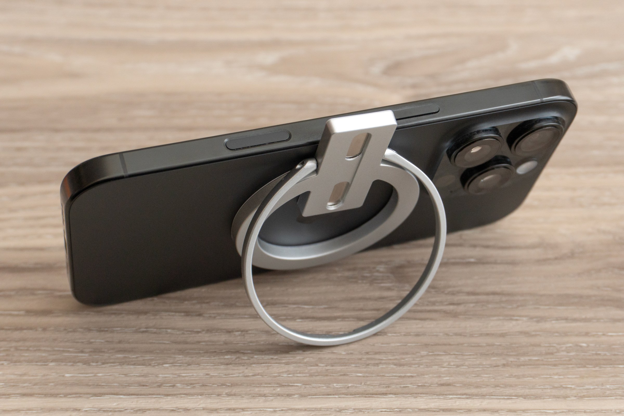 The Abxylute M4’s magnetic mount attached to an iPhone 16 Pro and supporting it like a stand.