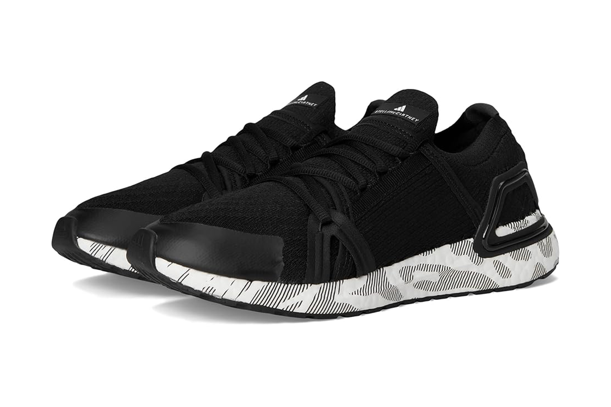 Pair of black Adidas sneakers with white and black patterned soles.