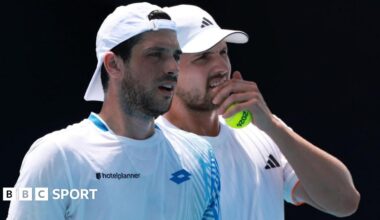 Julian Cash and Lloyd Glasspool discuss tactics during their Australian Open second-round match