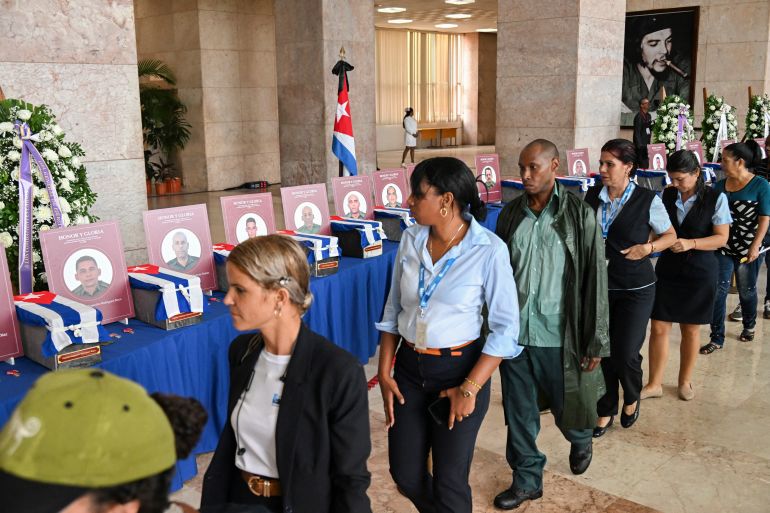 Cubans pay their respects during the funeral honors of the 32 Cuban soldiers who died during the US incursion to capture Venezuelan leader Nicolas Maduro, at the Ministry of the Revolutionary Armed Forces in Havana on January 15, 2026.
