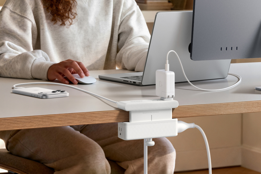 Anker’s Nano Power Strip in white clamped to the back of a wooden desk.