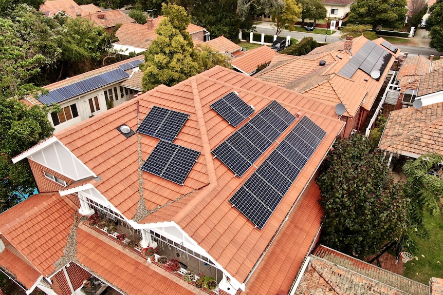 An aerial photo of a large house with solar panels on the roof.