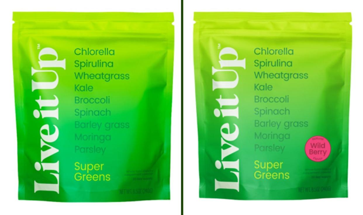 Two green pouches labeled "Live it Up Super Greens" list ingredients like chlorella, spirulina, and kale. The right pouch has a pink circle with "Wild Berry" on it; the left pouch does not.
