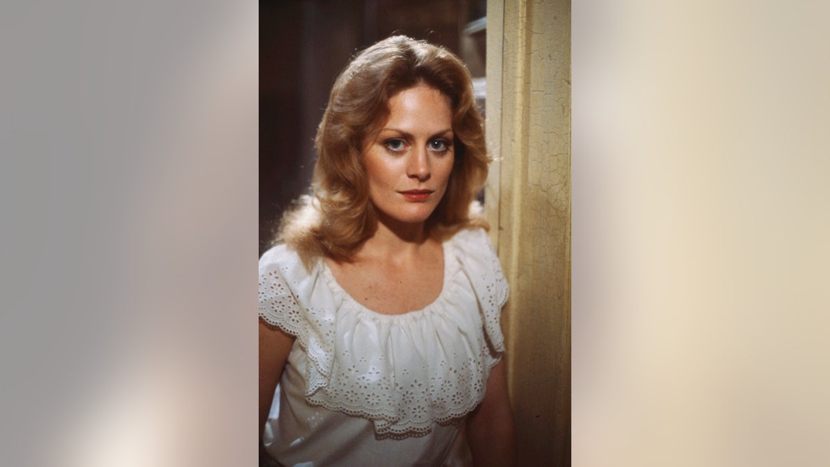 Beverly D'Angelo in a white dress.