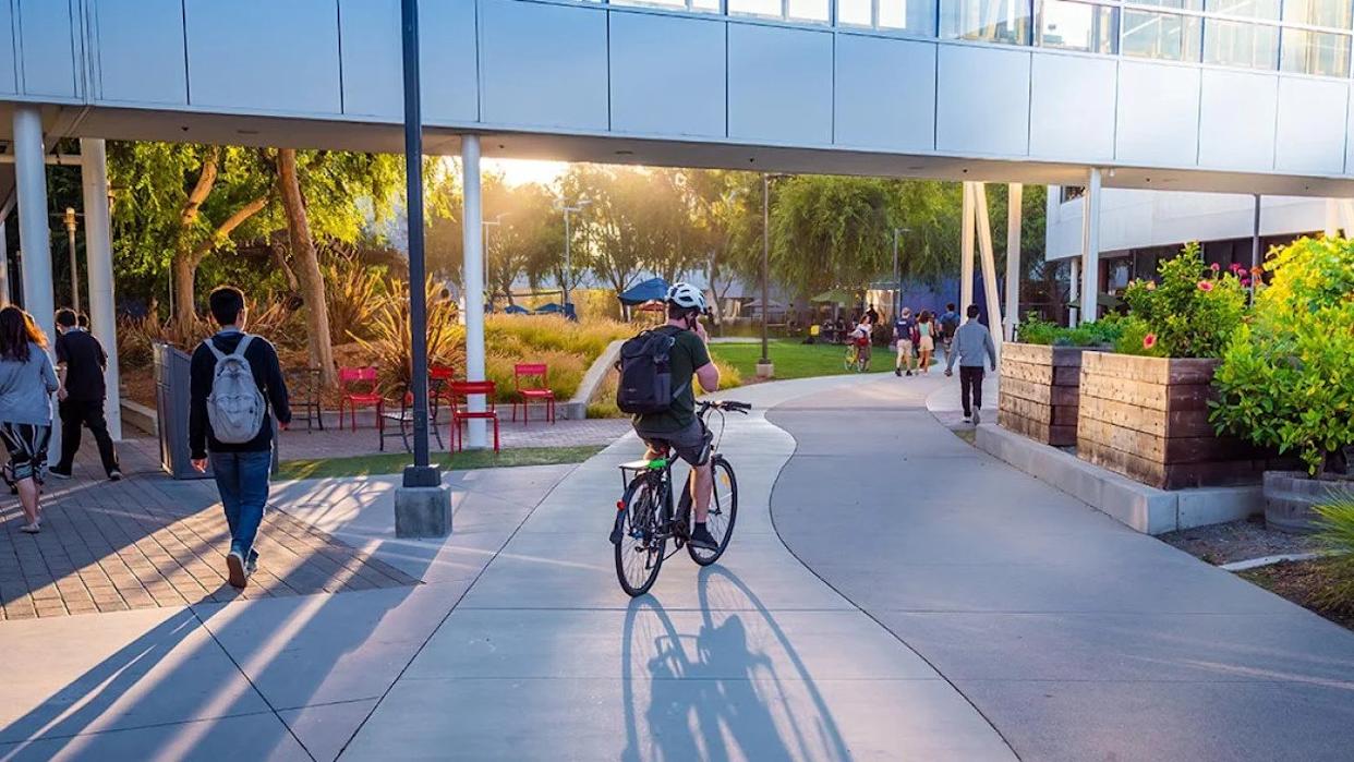 People walking and cycling around the Google headquarters. - arkanto // Shutterstock