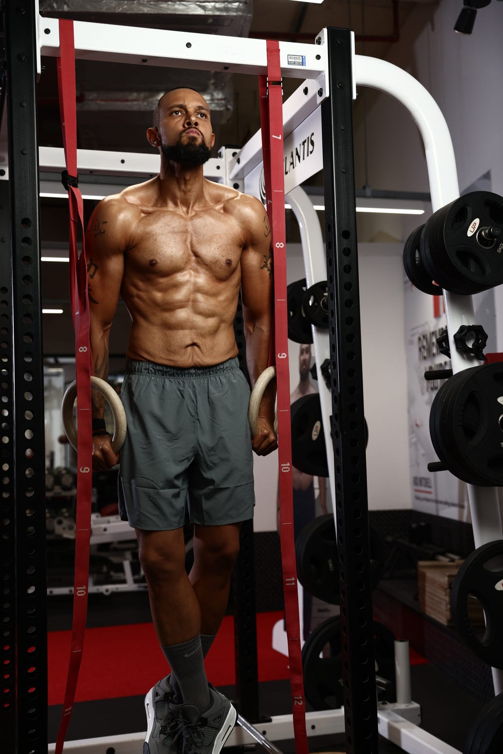 individual performing a muscleup exercise on gym rings