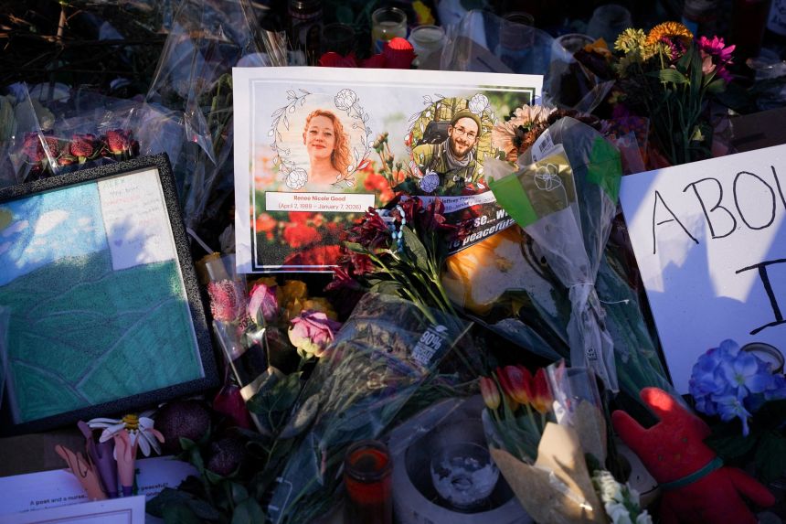 A card with images of Alex Pretti, who was fatally shot by federal immigration agents trying to detain him on January 24, and Renee Nicole Good, who was fatally shot by a U.S. Immigration and Customs Enforcement (ICE) agent on January 7, at a makeshift memorial at the site where Pretti was killed in Minneapolis, Minnesota.