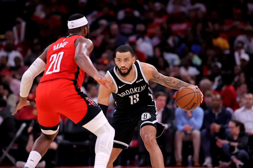Oct 27, 2025; Houston, Texas, USA; Brooklyn Nets guard Tyrese Martin (13) handles the ball against Houston Rockets guard Josh Okogie (20) during the third quarter at Toyota Center. Mandatory Credit: Erik Williams-Imagn Images