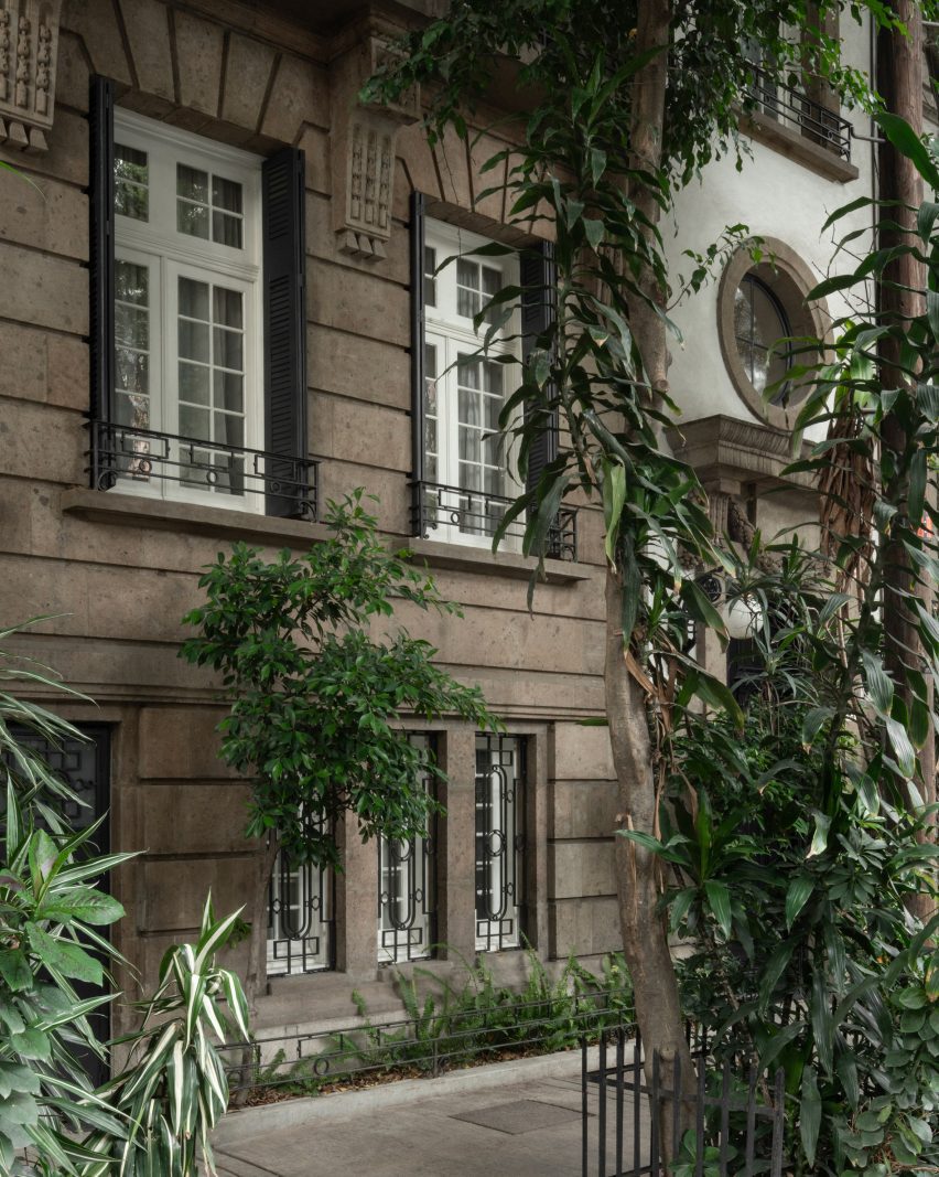 Exterior of a townhouse with a stone facade designed in an ornate French style