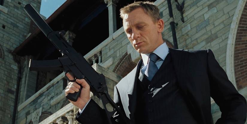 Daniel Craig with a gun looking down in Casino Royale.
