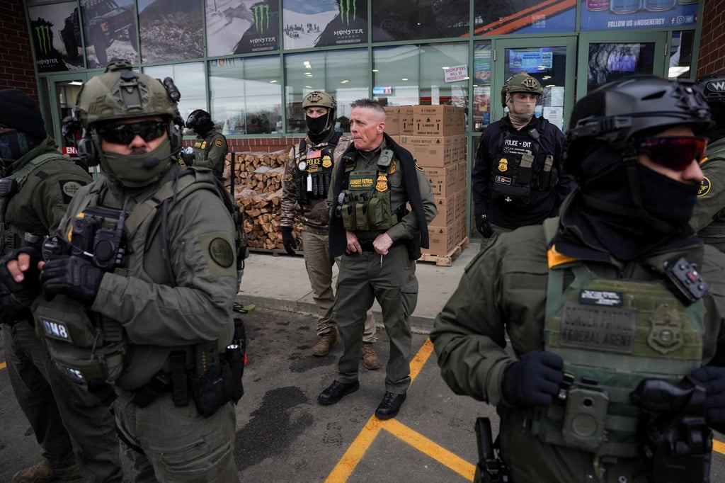 Greg Bovino accompanied by federal agents at a petrol station. Photo: Reuters