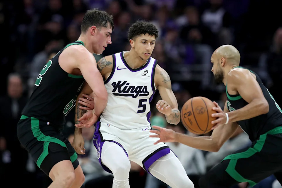 Jan 1, 2026; Sacramento, California, USA; Boston Celtics forward Luka Garza (52) sets a screen on Sacramento Kings guard Nique Clifford (5) during the fourth quarter at Golden 1 Center. Mandatory Credit: Dennis Lee-Imagn Images