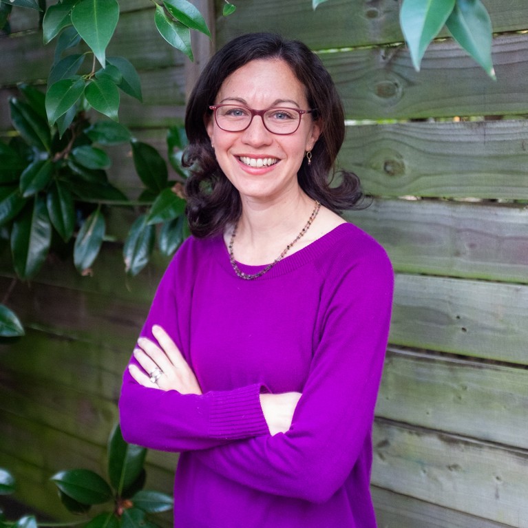 Julia Schechter stands with her arms folded