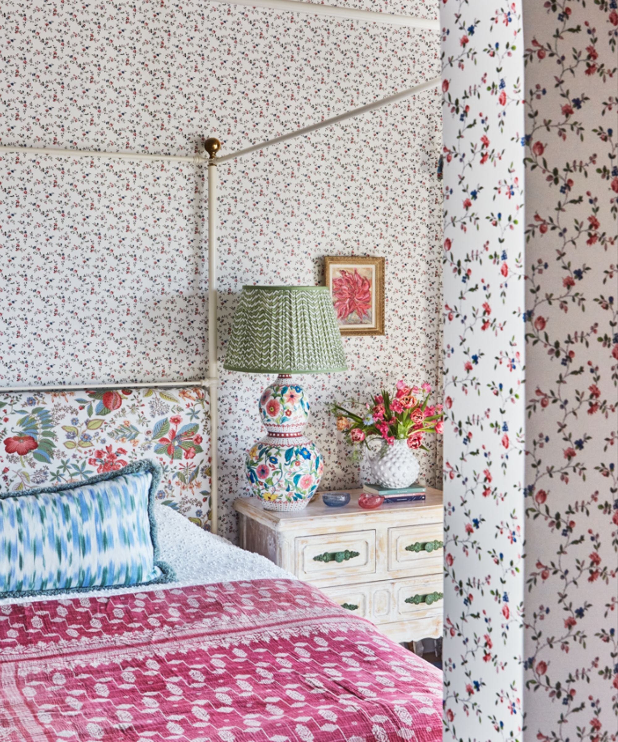 floral master bedroom with a four poster bed and a small dressing room