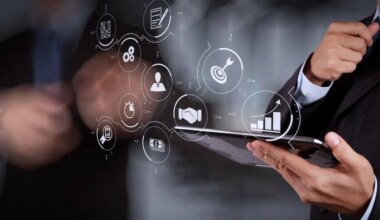 close up of businessman holding a tablet with digital process icons overlaid on the image