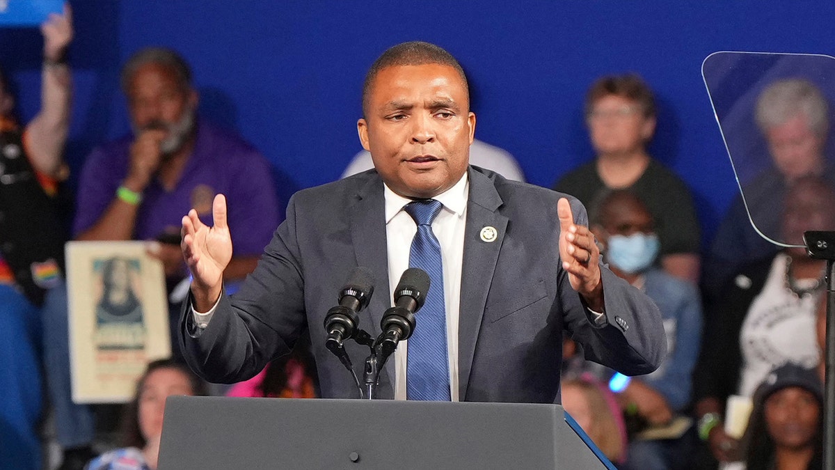 don davis in grey suit speaking at campaign event