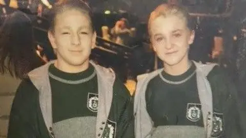 David Holmes David and Tom dressed as Draco Malfoy, with slicked back blonde hair. It is a low-resolution image - probably a picture of a hard copy photo.