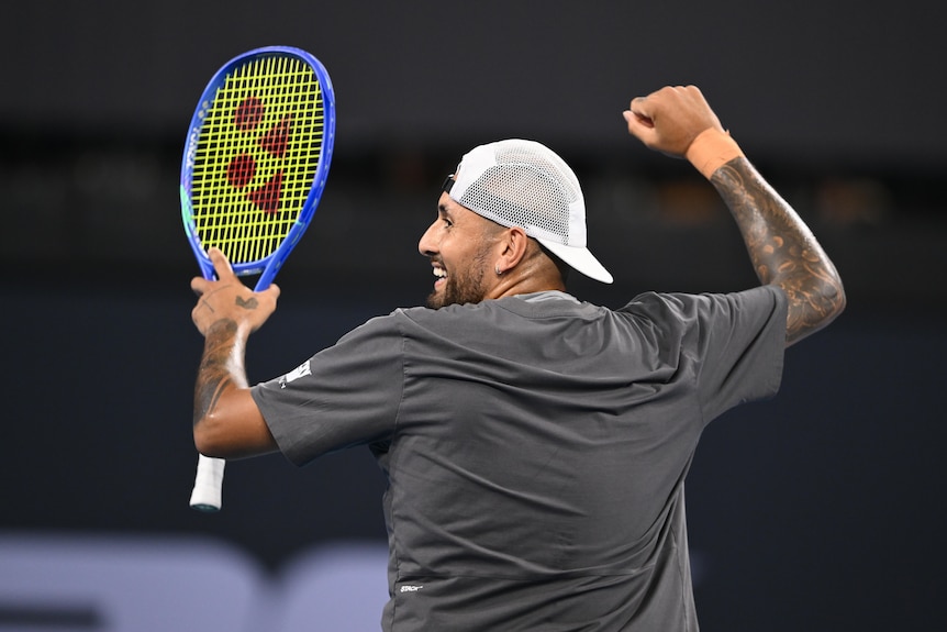 Nick Kyrgios smiles and dances