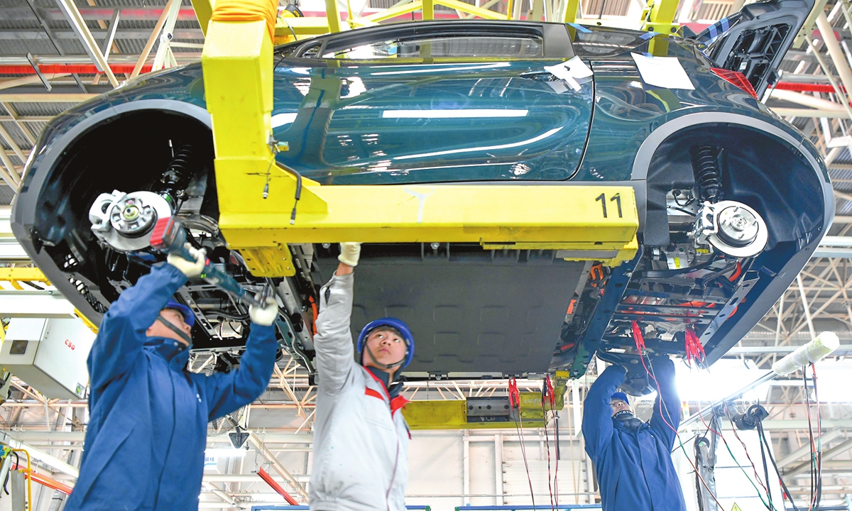 Workers assemble a new-energy vehicle at a manufacturing plant in Shijiazhuang, North China's Hebei Province, on December 24, 2025. From January to November this year, China's automobile production reached 31.231 million units, up 11.9 percent year-on-year, and sales reached 31.127 million units, up 11.4 percent year-on-year, according to official data. Photo: VCG