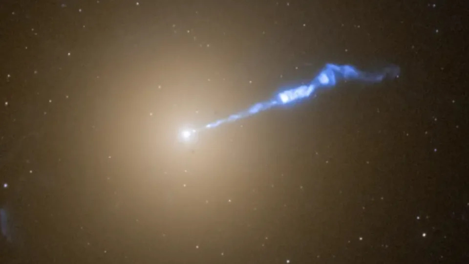 M87* and its cosmic blowtorch-like jet as seen by the Hubble Space Telescope.