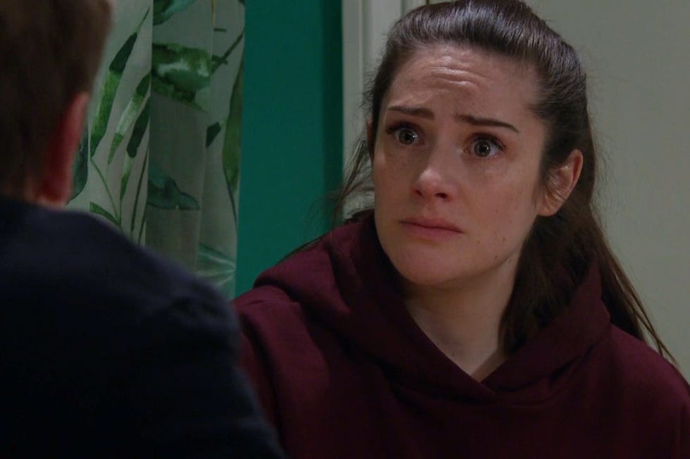 two individuals engaged in conversation in an indoor setting